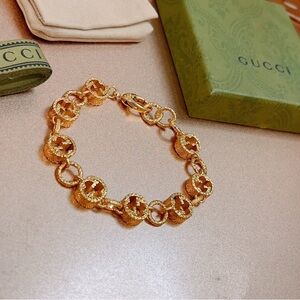 Gucci Gold Tone Textured Charm Wristlet